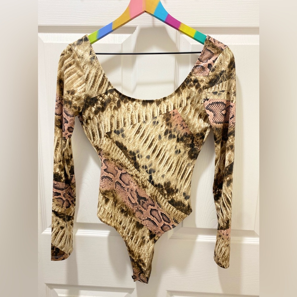 Women's long sleeve snakeskin bodysuit.  small size, new without tags.